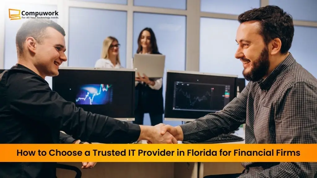 “Business professionals shaking hands in an office with computer monitors displaying financial data, representing choosing a trusted IT managed service provider in Florida for financial firms.